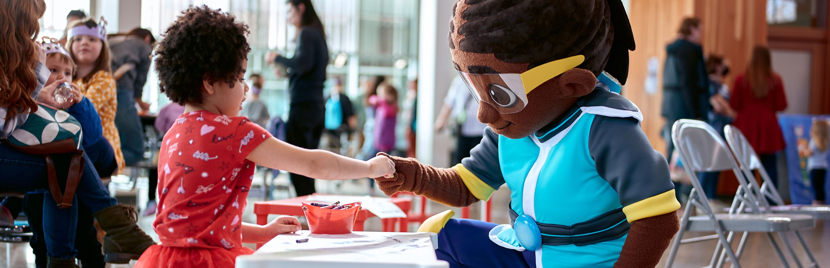 Young girl shaking hands with Skillsville mascot Par-Cora
